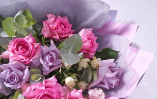 Close-up of a colorful bouquet of flowers. Big pink roses. On a light background, top view, copy space. High quality photo